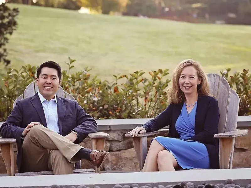 Dr. Jimmy Lee and Dr. Krista Davis sitting together outdoors.